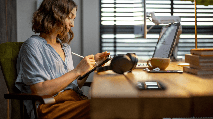 Woman using tablet at desk